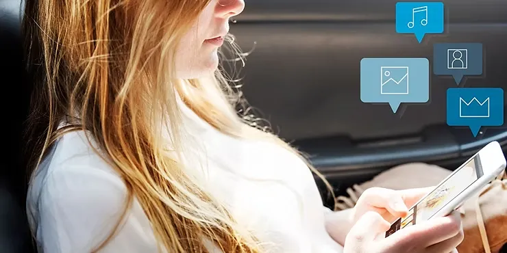 Woman With Long Hair Using A Tablet In A Car, Icons For Music, Photos, And Profiles Floating Above, Creating A Digital, Focused Mood